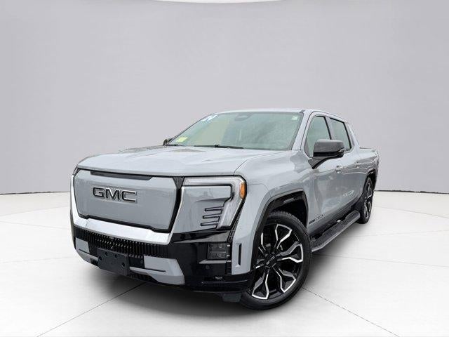 2024 GMC Sierra EV Denali Edition 1 in Thunderstorm Gray — front three-quarter view
